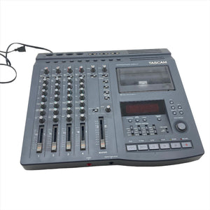 Tascam Portastudio 424 MKII Multi-Track Cassette Recorder with knobs and cables, ideal for analog recording and mixing up to four tracks.