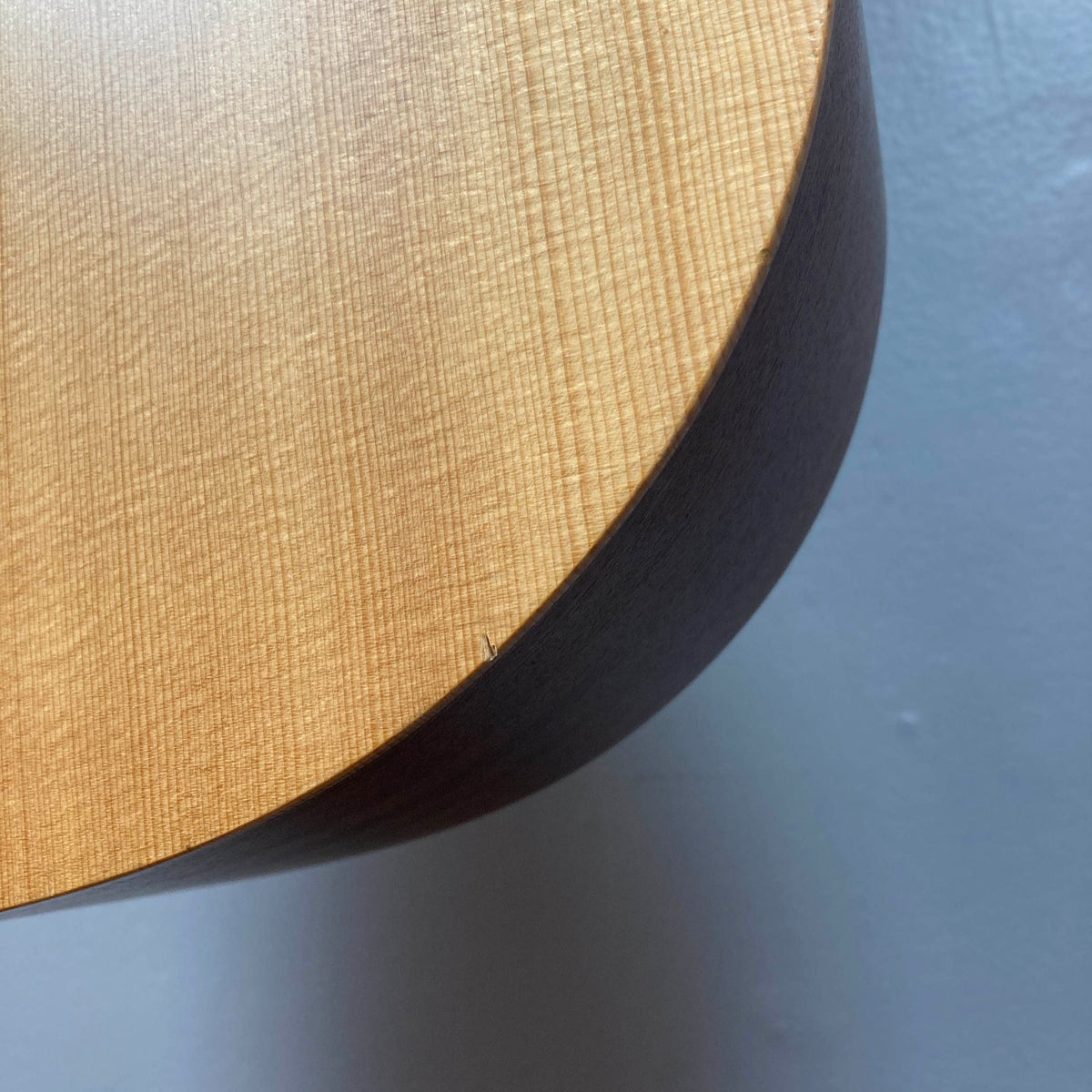 Close-up of a Taylor Academy 10e Acoustic-Electric Guitar w/GigBag Used body showing a small crack along the edge.