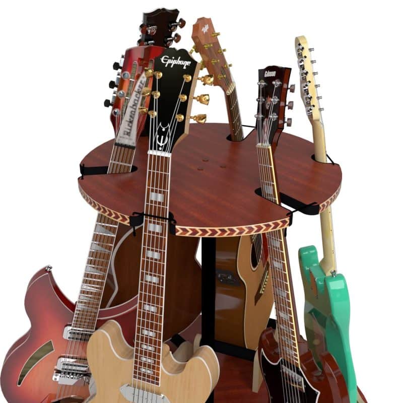 The Carousel™ Deluxe Rotating Guitar Stand by A&S Crafted Products holds multiple electric and acoustic guitars upright in a circular arrangement for an organized display.