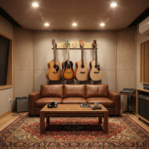 A modern recording studio features the A&S Crafted Products Pro-File™ Wall-Mounted Guitar Hanger showcasing four guitars, plus a brown leather sofa, wooden coffee table, and audio equipment on both sides.