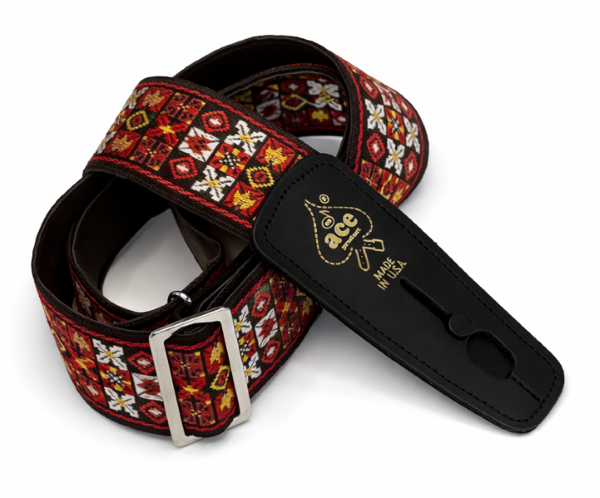 The D'Andrea Ace Pro Lock-It 2" Jacquard Guitar Strap features a red, yellow, and white geometric design, silver buckle, black leather ends stamped “ace” and “Made in USA,” inspired by vintage Ace straps.