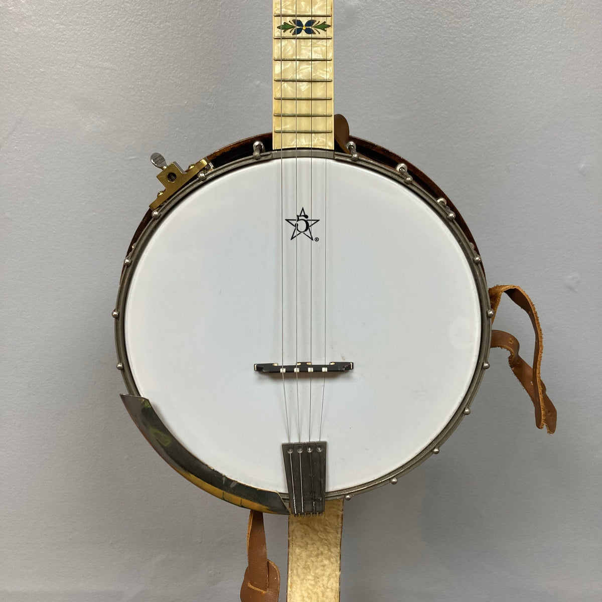 Vintage 1920-1930s Gretsch Broadkaster 4-String Tenor Banjo with white band, brown leather straps, and nickel-plated hardware, showcasing iconic Gretsch logo and floral inlay.