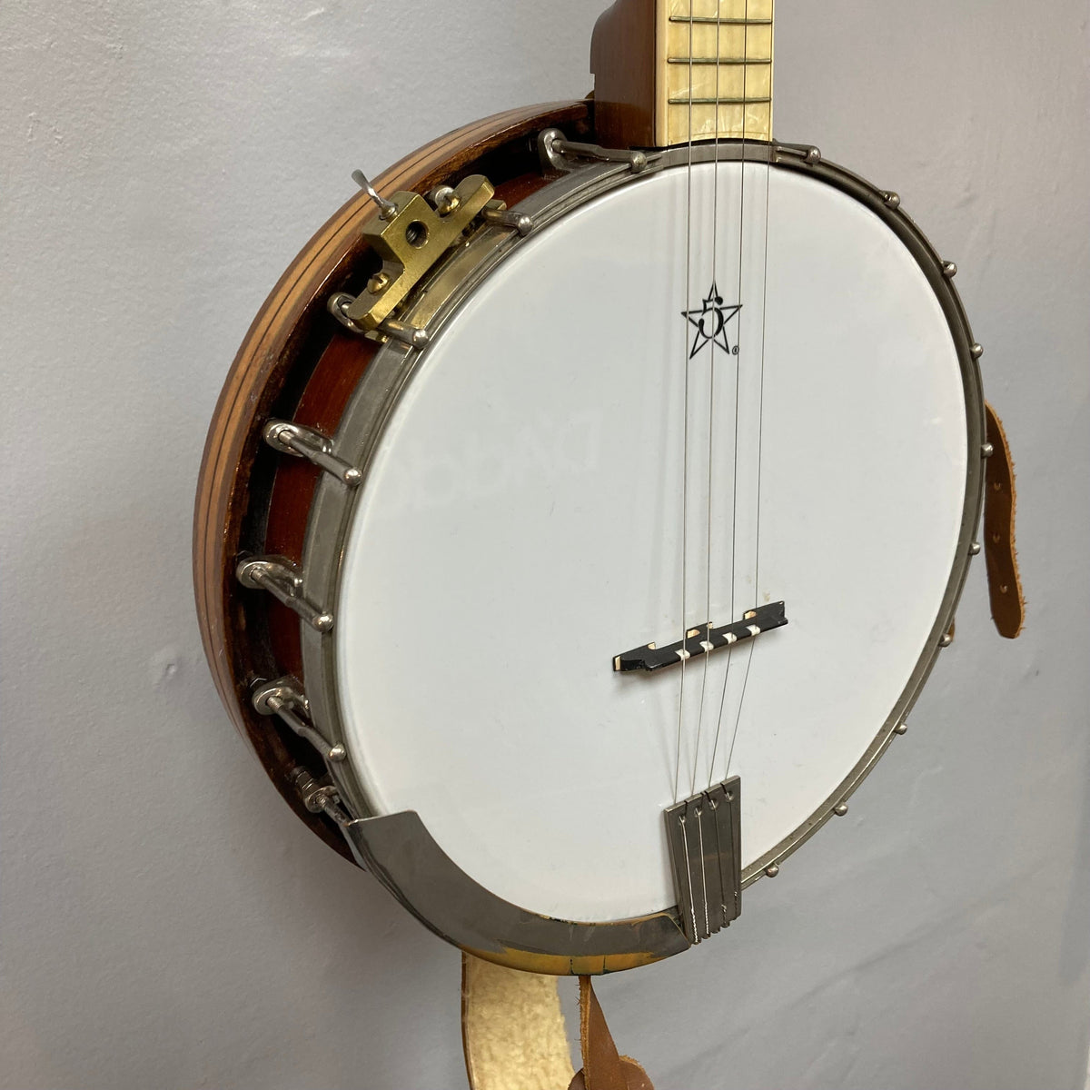 Vintage 1920-1930s Gretsch Broadkaster 4-String Tenor Banjo on display, showcasing detailed craftsmanship, iconic headstock logo, and intricate floral inlay.