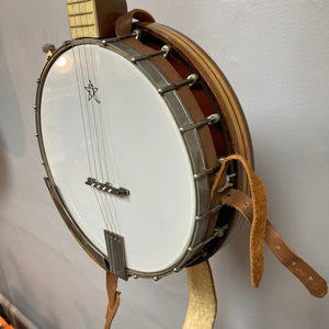 Vintage 1920-1930s Gretsch Broadkaster 4 String Tenor Banjo mounted on a wall, showcasing its maple body, iconic headstock, and nickel-plated hardware.