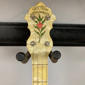 Close-up of the Vintage 1920-1930s Gretsch Broadkaster 4-String Tenor Banjo, showcasing its maple body, headstock with floral inlay, and nickel-plated hardware.