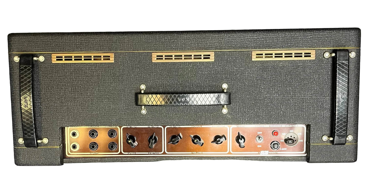 Rear view of a Vintage 1963 Vox AC30/6 Normal by Vox, featuring original JMI Egg Footswitch, flight case, Woden transformers, multiple jacks, control knobs, ventilation slots, and carrying handle.
