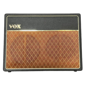 Front view of a Vintage 1963 Vox AC30/6 Normal amplifier by Vox, featuring a black and brown diamond-patterned grille, gold trim, classic Celestion Blue T530 speaker, original JMI egg footswitch, and flight case.