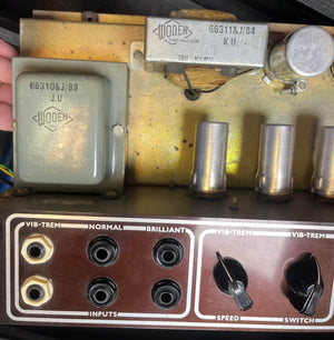 Close-up of a vintage 1963 Vox AC30/6 Normal amplifier by Vox, featuring input jacks, control knobs, original JMI egg footswitch, flight case, and Woden transformers with clear labels and serial numbers.