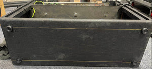 A vintage 1963 Vox AC30/6 Normal amplifier by Vox, shown from below with its original JMI egg footswitch and flight case. Four rubber feet and some surface wear are visible.