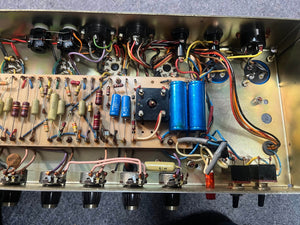 Internal view of a 1971 Marshall 50W Lead Head (JMP Era), showing resistors, capacitors, wires, and tubes on the metal chassis—a classic Marshall amp famed for its British sound. Includes flight case.
