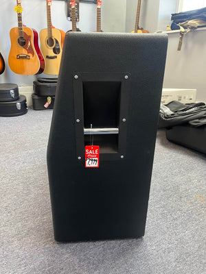A 1969 Marshall 4x12 Cabinet with Matching Celestion T1281 Greenbacks featuring a metal handle and $799 red sale tag is displayed in a music store, surrounded by guitars hanging in the background.