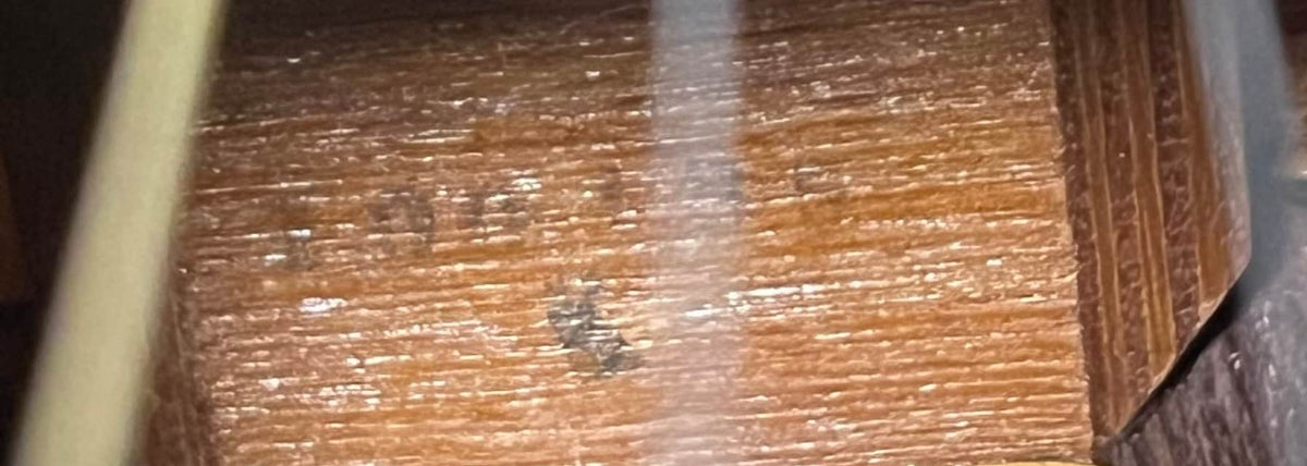 Close-up of the textured brown wood surface with faint black markings and a white streak, echoing the craftsmanship found on the Sigma Vintage DR-35 Acoustic Guitar w/case (Made in Japan).