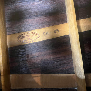 Close-up of a Vintage Sigma DR-35 Acoustic Guitar interior shows the "SIGMA GUITARS MADE IN JAPAN FOR C.F. MARTIN & CO. DR-35" stamp, wood braces, and grain, highlighting this Sigma model inspired by the Martin D-35. Includes case.