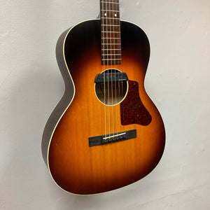 The Waterloo WL-12 Parlor Acoustic w/Case Used Consign by Waterloo is a vintage-style sunburst guitar with six strings, tortoiseshell pickguard, and white binding, perfect for classic tones and look.