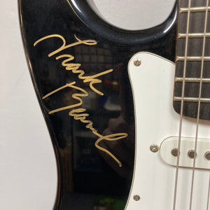 Close-up of a Strat style guitar signed by ZZ Top members, featuring detailed strings and neck, available exclusively at Guitars on Main.