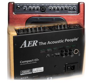 Close-up of AER Compact 60/4 OMH Stained Oak amplifier, showcasing control knobs and input jacks for acoustic instruments. Ideal for stage, studio, and home use.