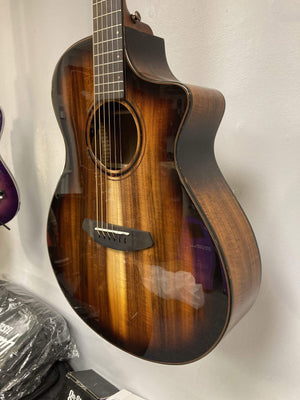 Breedlove Pursuit Exotic S Concert Edgeburst CE Koa-Koa guitar on display, highlighting its elegant design and craftsmanship.