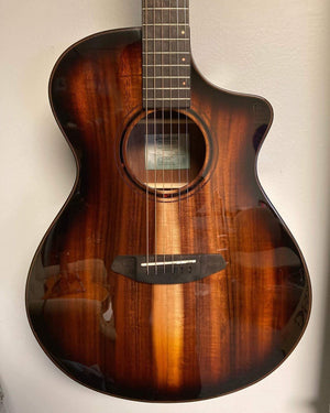 Breedlove Pursuit Exotic S Concert Edgeburst CE Koa-Koa, close-up of the acoustic guitar showcasing its strings and detailed craftsmanship.