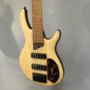 Cort Artisan B5 Element Natural electric bass guitar on display, highlighting its refined craftsmanship and high-quality components.