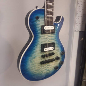 Blue Dean Thoroughbred Select Quilt Top OSB electric guitar with satin neck finish and ebony fingerboard, displayed on a wall.