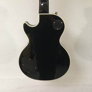 2022 Epiphone Les Paul Custom Ebony with sleek black finish, cream binding, and visible control covers, highlighting Gibson pickups.