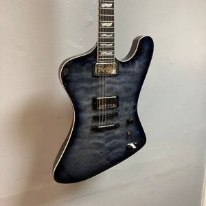 ESP LTD Phoenix-1000 QM See-thru Black Sunburst electric guitar on display, highlighting its quilted maple top and sleek design.