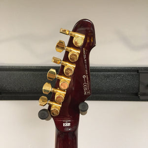 Close-up of the ESP LTD Phoenix-1000 guitar in See Thru Black Cherry, showcasing gold hardware, Fishman Fluence pickups, and mahogany body.