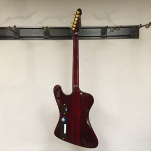 ESP LTD Phoenix-1000 - See Thru Black Cherry electric guitar on a hook, showcasing its sleek design and high-quality build.