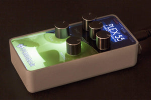 Close-up of the Foxgear Plex 55 preamp, featuring knobs and a black cylindrical component, designed to mimic tube amplifier tones for guitarists.