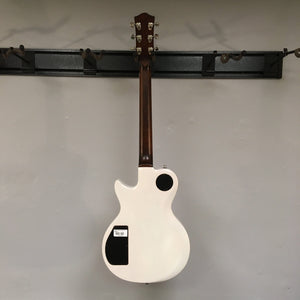 Godin Summit Classic HT Trans White Electric Guitar with brown neck, chambered body, and dual humbuckers, displayed on a wall.