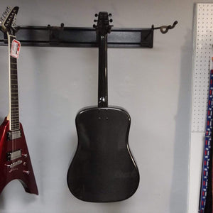 Klos Full Carbon Deluxe Acoustic Electric Guitar mounted on a wall, featuring a detachable neck and custom gig bag, perfect for versatile, durable performance.