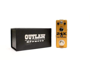 Outlaw 24K Reverb Guitar Pedal next to its black box, featuring three reverb modes: Room, Plate, and Spring for versatile sound enhancement.