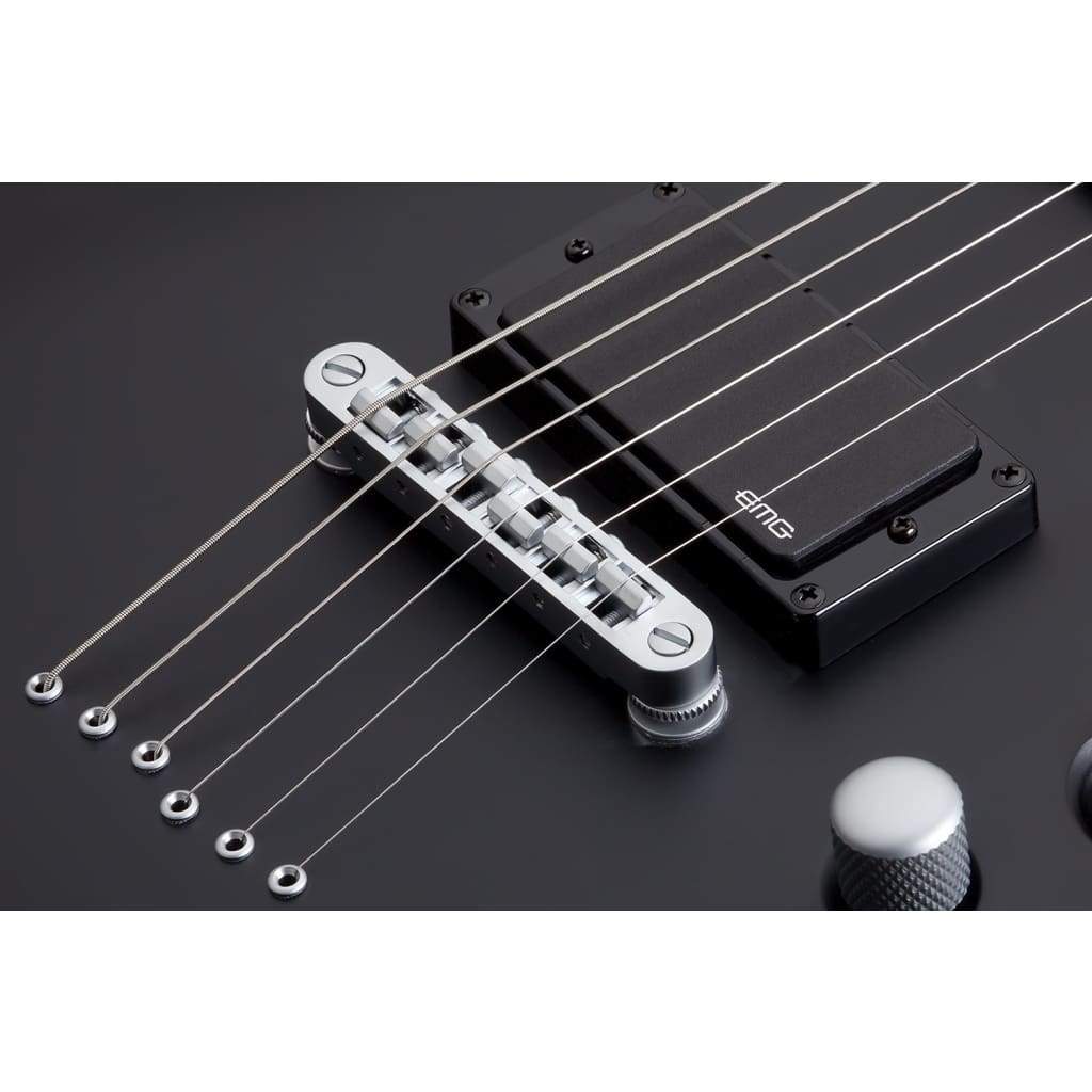 Close-up of the Damien Platinum-6 guitar&#39;s bridge and strings, highlighting its precision construction and attention to detail for superior playability and tone.