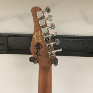 Close-up of Schecter Nick Johnston Traditional Atomic Frost Electric Guitar, showcasing the strings, fretboard, and body details.