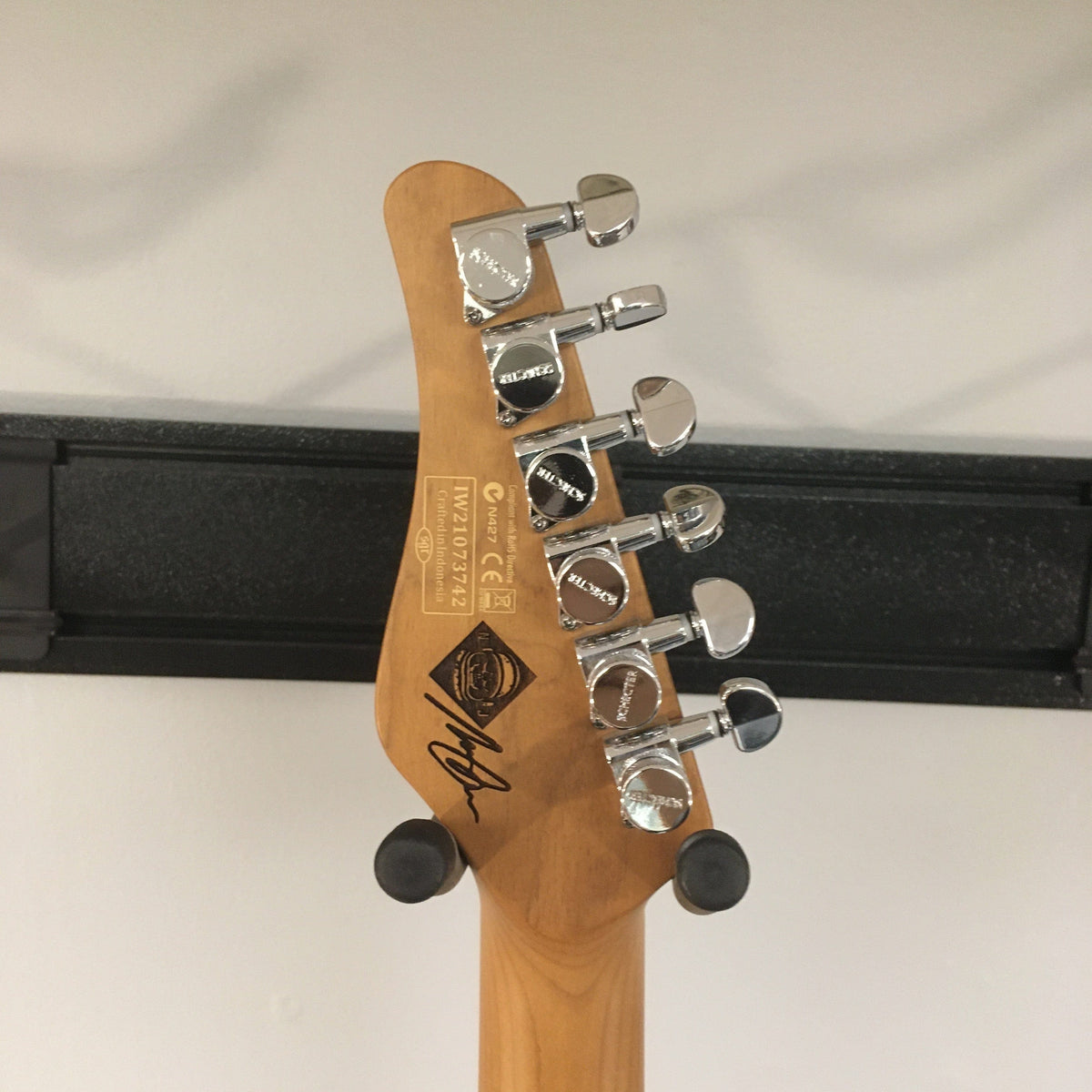 Schecter Nick Johnston Traditional Atomic Ink Open Box electric guitar headstock with silver knobs and vintage-style tuning pegs.