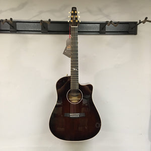 Seagull Artist Peppino Signature acoustic guitar with solid spruce top, displayed on a wall.