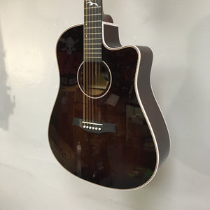 Seagull Artist Peppino Signature Acoustic Guitar hanging on a wall, showcasing its solid spruce top and mahogany body.