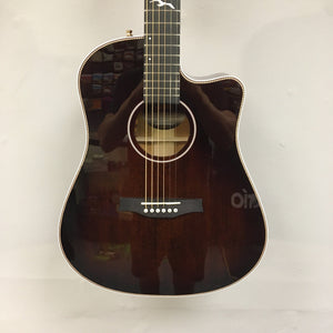 Seagull Artist Peppino Signature Acoustic Guitar with solid spruce top and solid mahogany body, displayed on a wall.