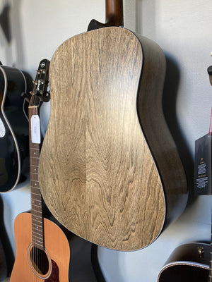 Seagull S6 Classic A/E Black guitar leaning against a wall with visible Fishman Sonitone preamp system.