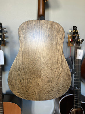 Seagull S6 Classic A/E Black guitar on shelf, showcasing its black semi-gloss finish and solid cedar top.